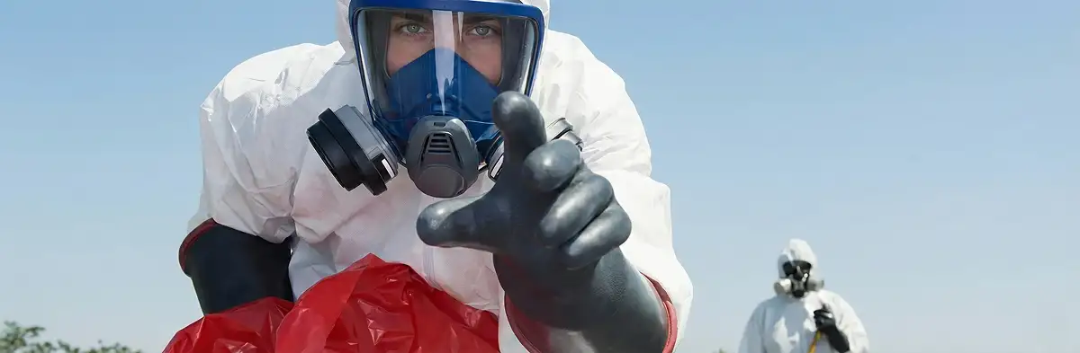sewage clean up technician wearing protective gear handling biohazard materials in Seattle, WA