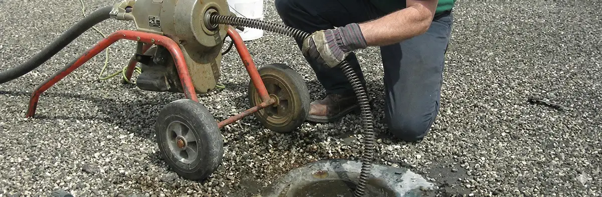 sewer rodding technician actively removing blockages from a sewer line in Seattle, WA