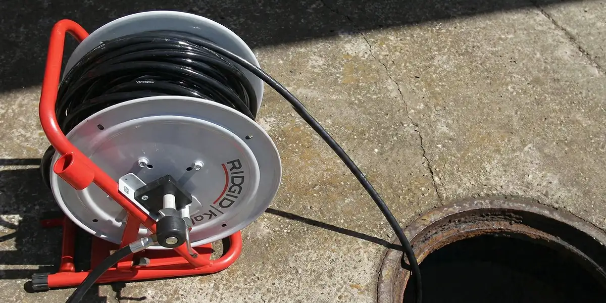 sewer rodding equipment prepared to clear clogged sewer lines in Seattle, WA